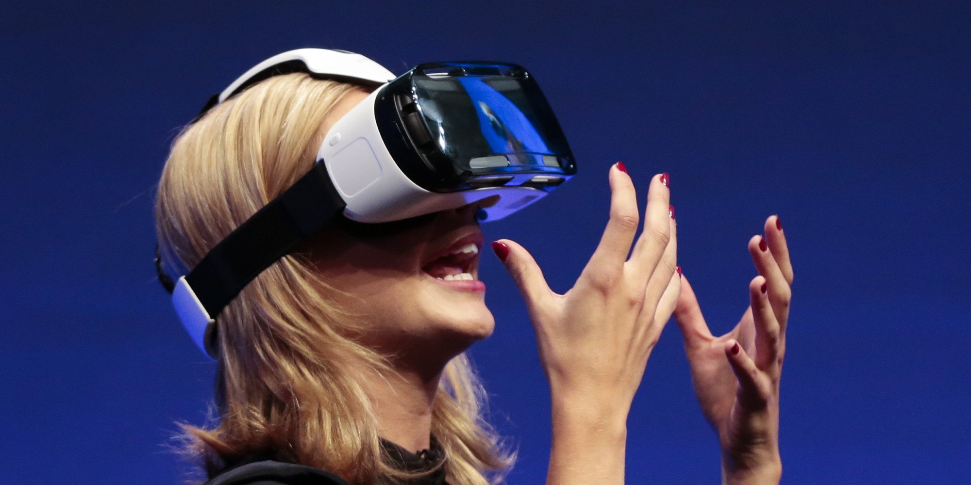 British television presenter Rachel Riley shows a virtual-reality headset called Gear VR during an unpacked event of Samsung ahead of the consumer electronic fair IFA in Berlin, Wednesday, Sept. 3, 2014. (AP Photo/Markus Schreiber)