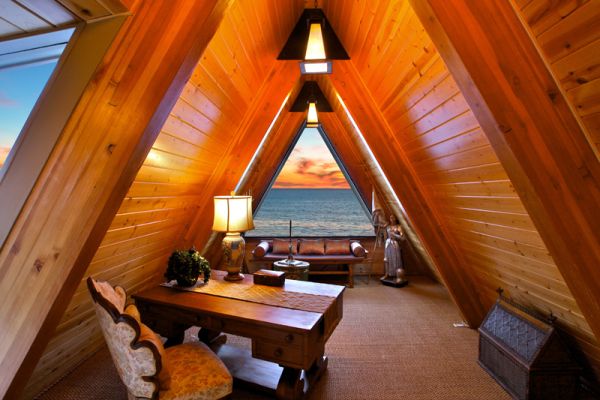 inviting-yet-dramatic-attic-home-office-featuring-a-large-triangular-window-with-panoramic-views