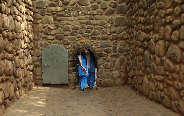 CHANDIGARH, INDIA - MARCH 26:  School girls walk through a doorway at the Rock Garden on March 26, 2010 in Chandigarh, India. The 12-acre Rock Garden which began as secret project of Nek Chand in 1957, was declared as public space in 1976 and houses artworks created using a variety of urban and industrial waste.  (Photo by Mark Kolbe/Getty Images)