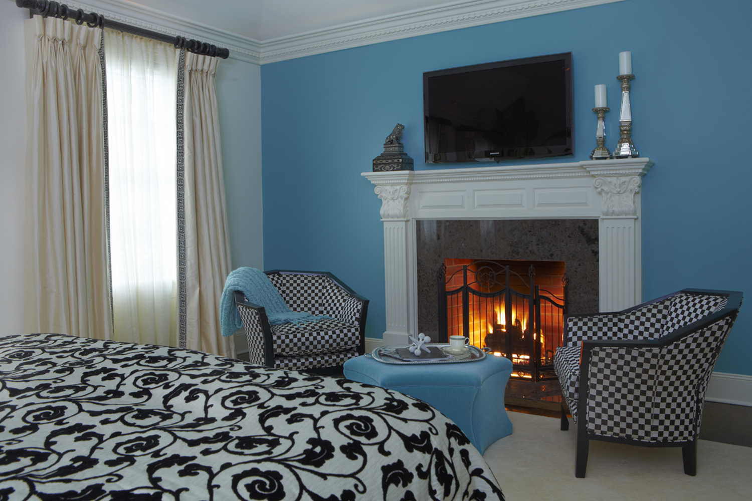 modern-master-bedroom-with-fireplaces-and-antique-steel-fireplaces-screen-also-white-classic-fireplaces-mantel-and-shades-of-black-and-white-classic-chairs-and-blue-ocean-hexagon-coffee-table-and-beig