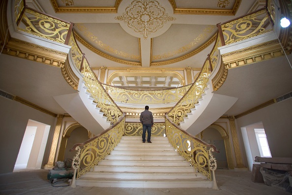 ERBIL, IRAQ - DECEMBER 15:  A construction worker walks up the staircase inside the replica White House, a $20 villa replica being built inside Dream City, a new exclusive residential suburb that is being developed in Erbil on December 15, 2014 in Erbil, Iraq. Dream City, is one of several high value residential areas that have been built in the Kurdistan capital since 2003 and are complete with their own mosque, shopping areas and schools. Property values vary, but many villas in the gated and walled development are now valued at over $1million and it even features a $20million US White House replica. Despite insecurity in the rest of Iraq, the semi autonomous region of Kurdistan has been seen by some investors as the new Dubai and although the advance of Islamic State and a budget row with Baghdad has dampened some of the enthusiasm, the city skyline is still changing at a rapid pace.  (Photo by Matt Cardy/Getty Images)