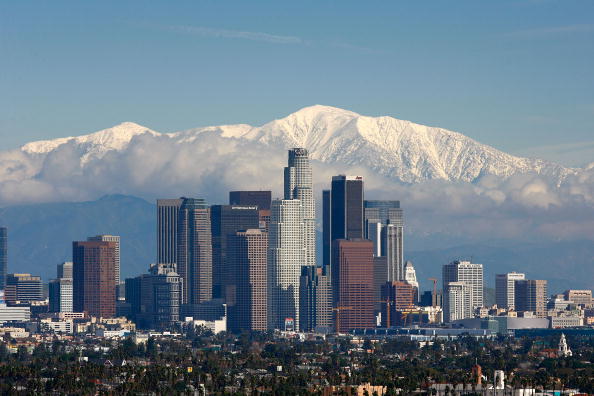 LOS ANGELES, CA - JANUARY 7:  Fresh snow blankets the mountains behind the downtown skyline after a series of storms that hammered northern California delivered much needed precipitation to the Greater Los Angeles Area January 7, 2008 in Los Angeles, California. With the threat of mandatory water rationing still in effect because of prolonged drought, the rain is a small step toward relief. Forecasters had predicted flash floods and mudslides near large areas that were denuded by wildfires of historic proportions in October, and some mandatory evacuations were declared, but little damage was reported.  (Photo by David McNew/Getty Images)