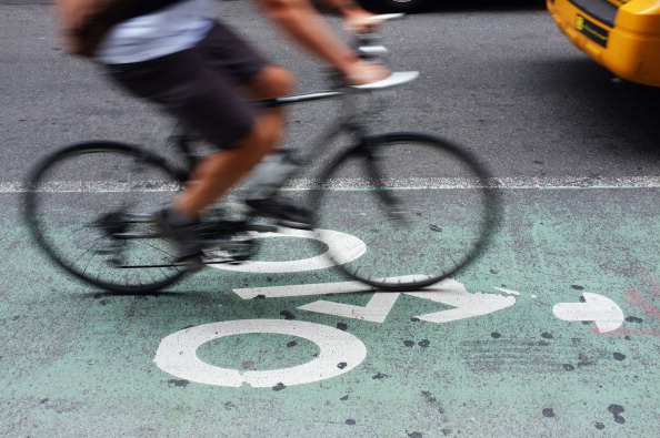 Commuter riding bike through the city