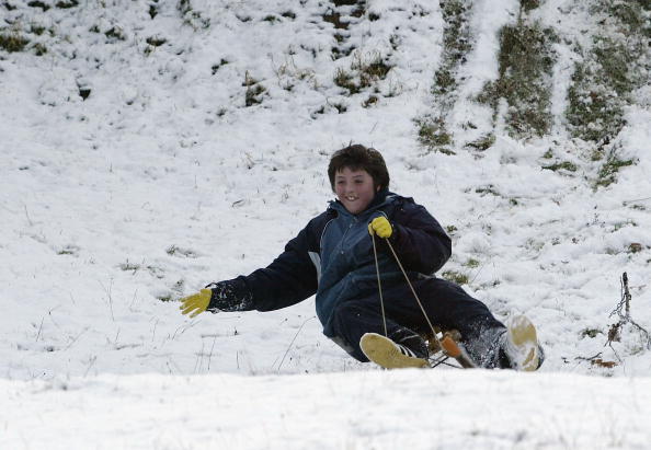 Kid Sledding Down Snow Hill