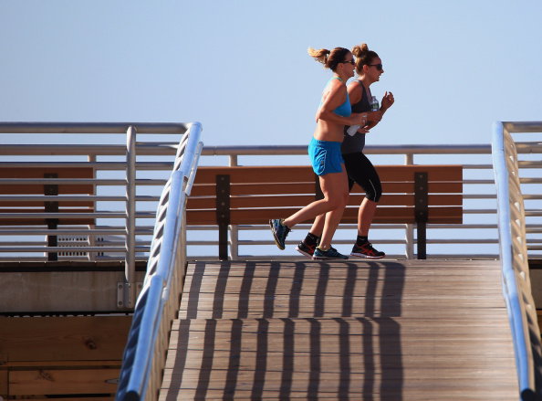 women jogging down the boardwalk