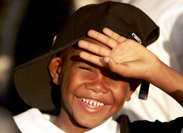 Little Boy Covering His Face From The Sun