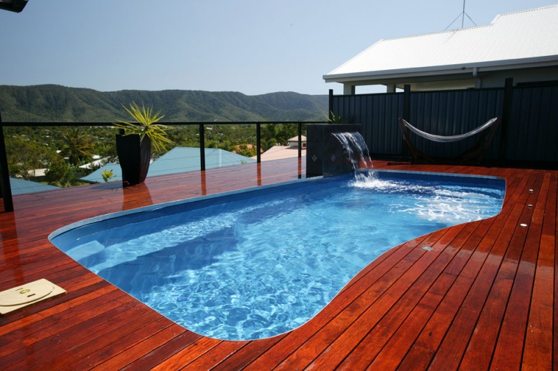 Backyard swimming pool with beautiful wooden deck