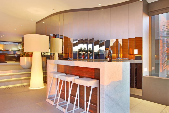 white marble bar with white stools