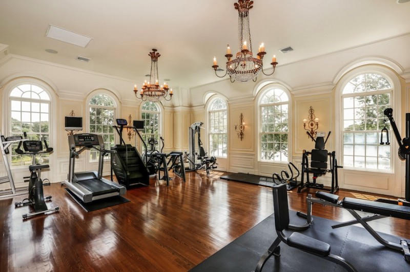 Home gym with chandelier and wood floor