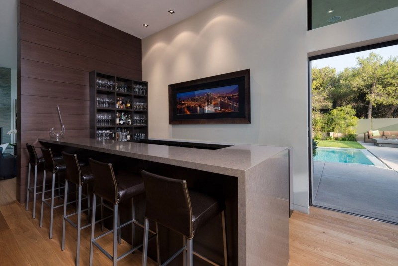 sleek bar with brown leather stools