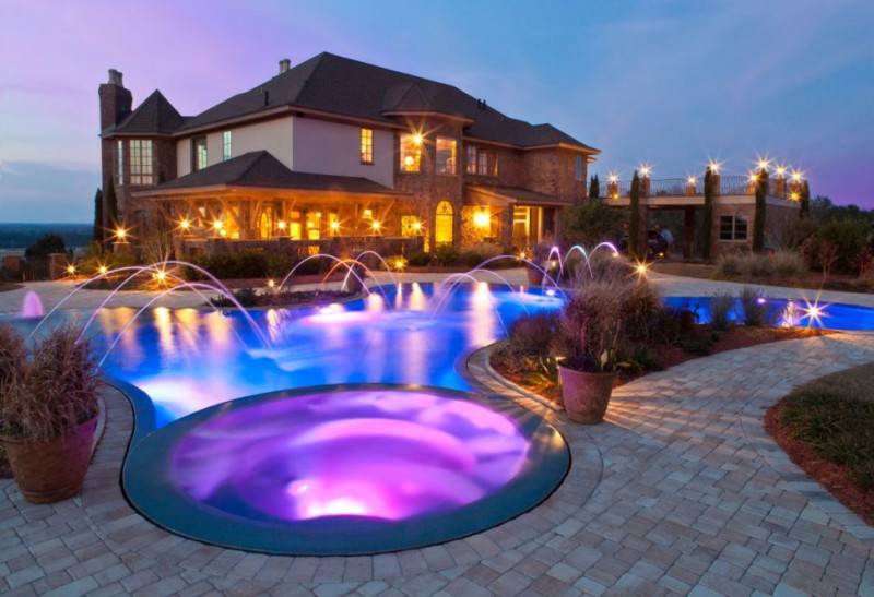 Backyard swimming pool with cool lighting