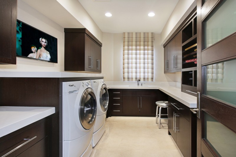 luxurious laundry room with dark wood cabinets