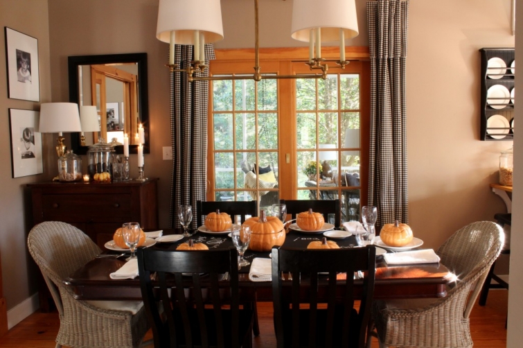 dining room with ceramic pumpkins and wicker chairs