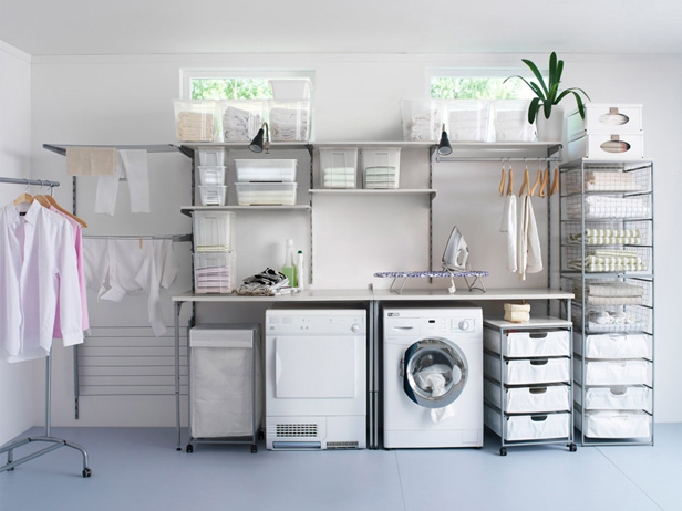 Laundry room with rolling shelves that pull out from desk area