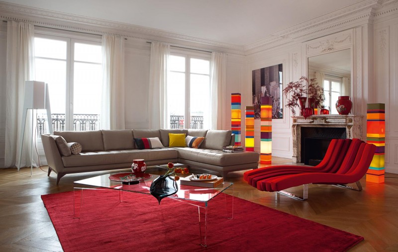 multi colored living room with red chaise