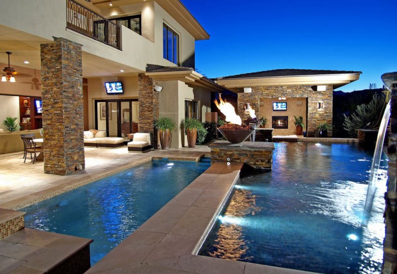 backyard pool with fire pit and waterfall