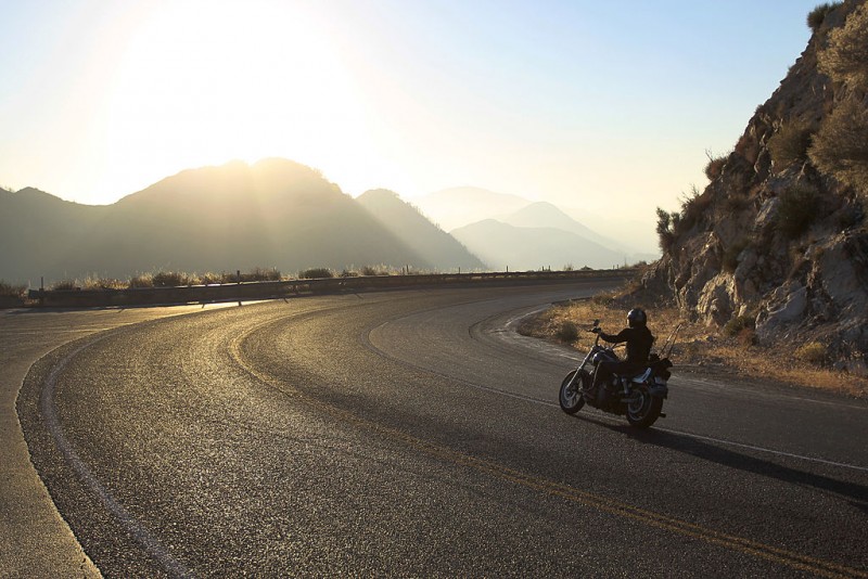 Man riding motorcycle on mountain road