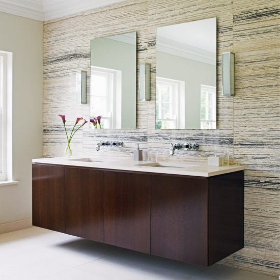 bathroom with light colored stone wall