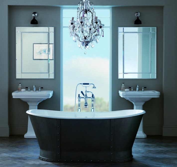 bespoke bathroom with black tub and chandelier