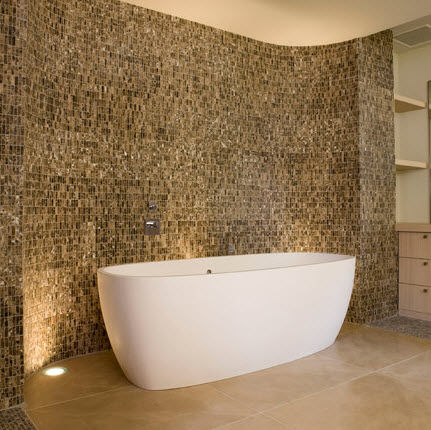 bathroom with stone walls and freestanding tub