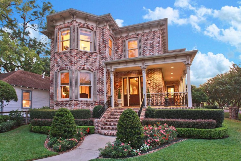 large brick house with wrap around porch