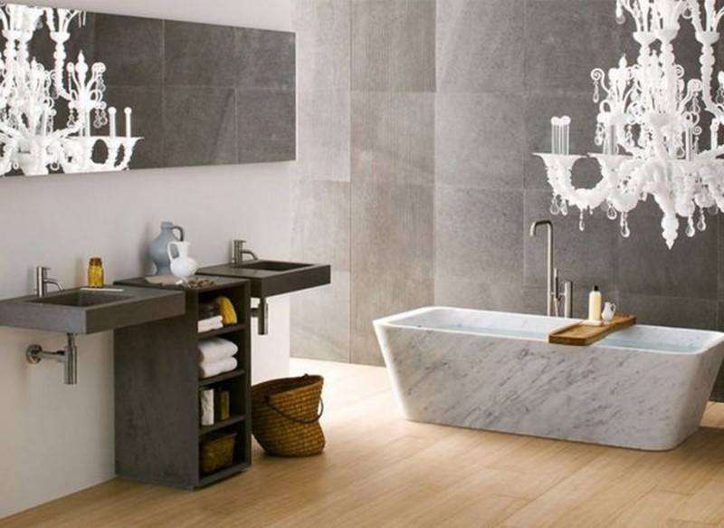 bathroom with marble tub and white chandelier