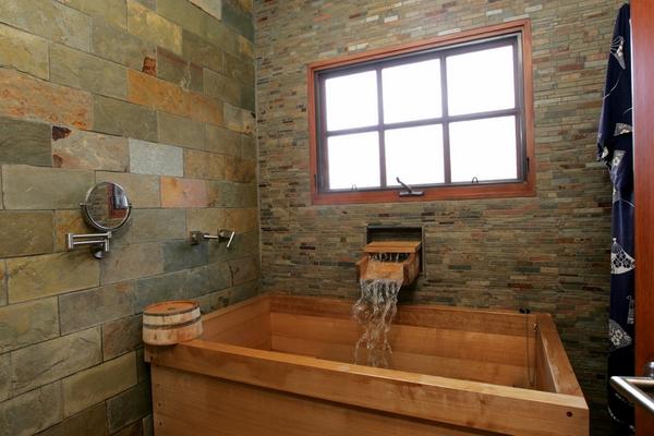 stone wall near japanese wood soaking tub