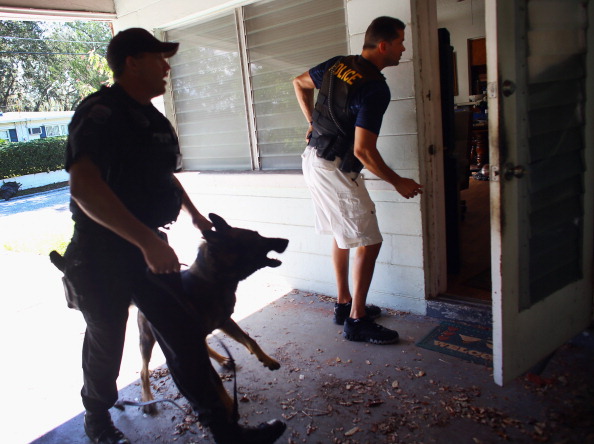 Police officers entering home