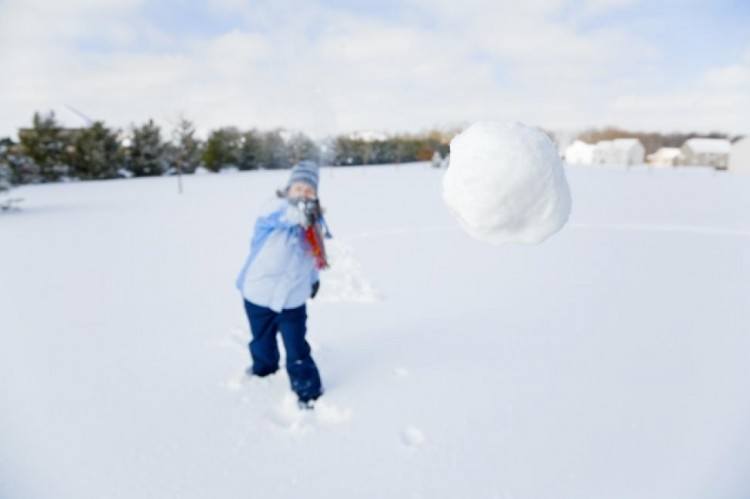 girl throwing snow ball