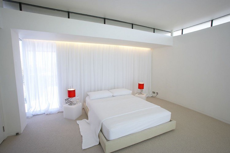 white master bedroom with red lamps