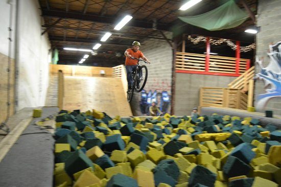 Man riding bike into foam pit