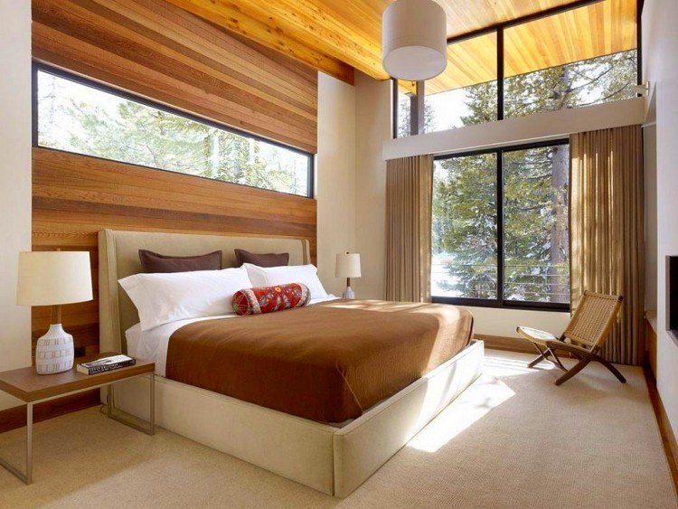 beautiful master bedroom with large windows