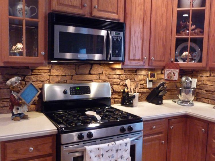 brown kitchen with stone backsplash