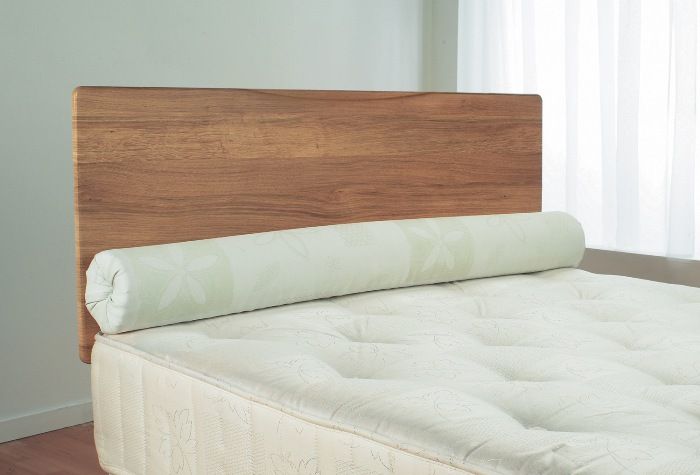 simple bed with wooden headboard