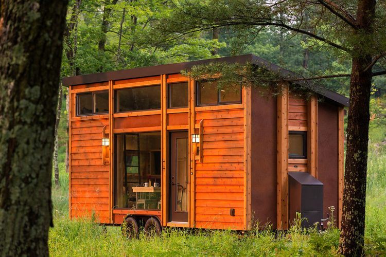 tiny square wooden house in the woods