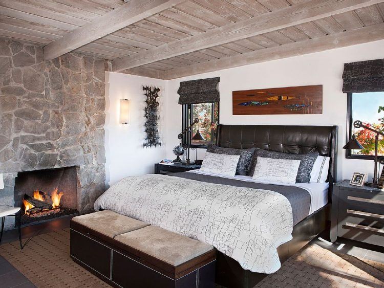 luxurious master bedroom with large fireplace