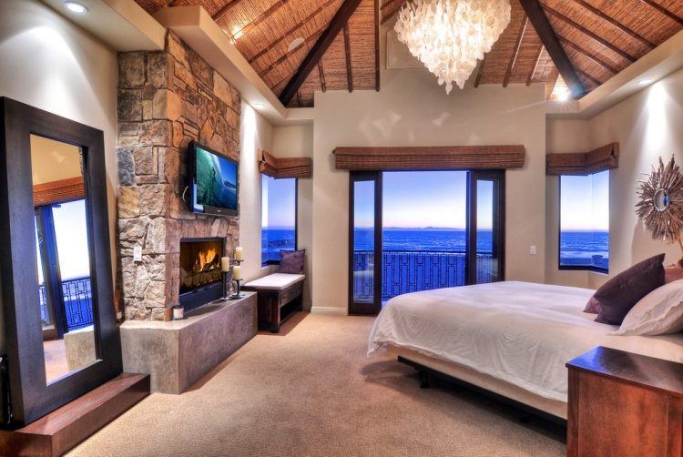 bedroom with crystal chandeliers and fireplace