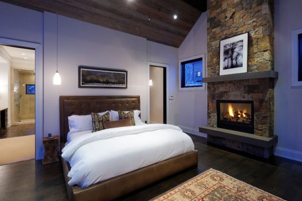 bedroom with wooden ceiling and fireplace