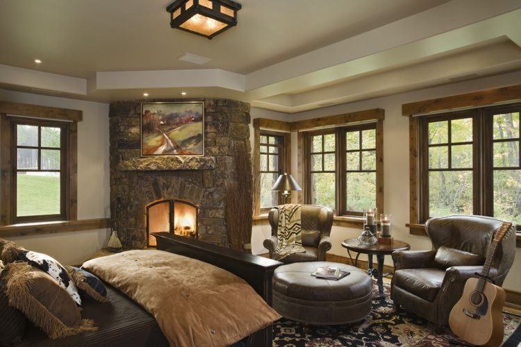 modern bedroom with stone stacked fireplace