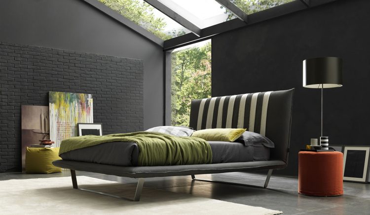 bedroom with cool black brick accent wall