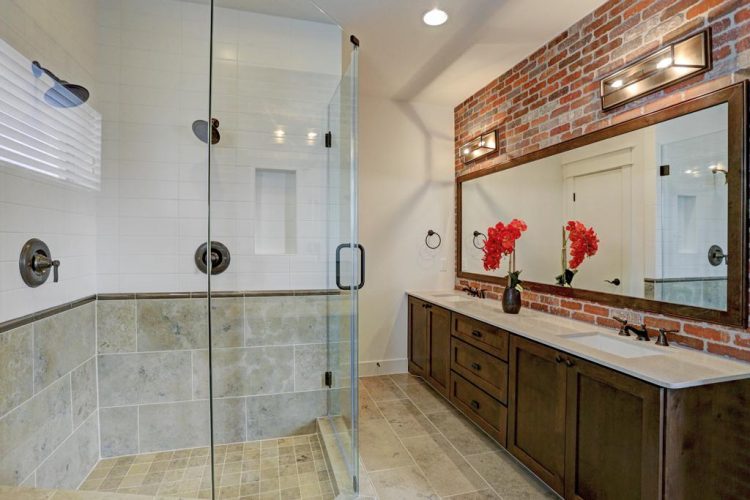 bathroom with brick accent wall