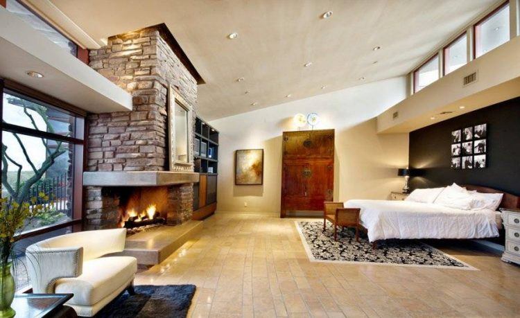 master bedroom with floor to ceiling fireplace design