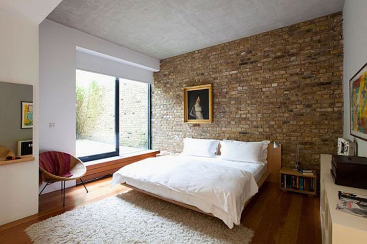 men's bedroom with brick accent wall