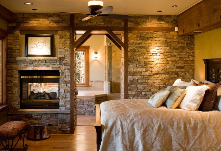 rustic bedroom with stone wall