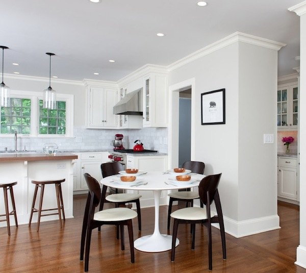 Small kitchen dining area with black chairs