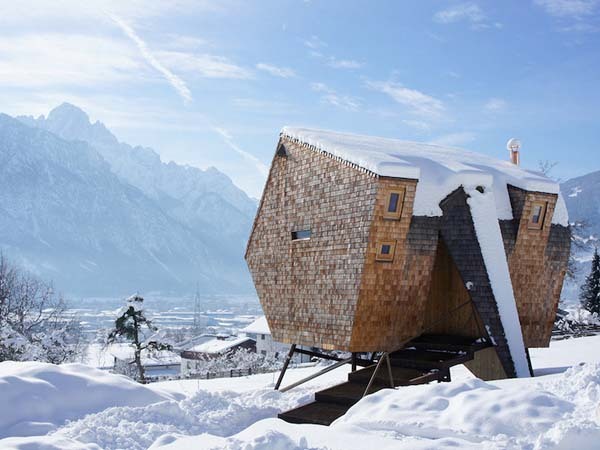 strange tiny home covered in snow