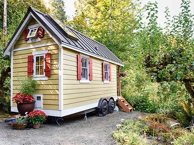 yellow tiny home on wheels