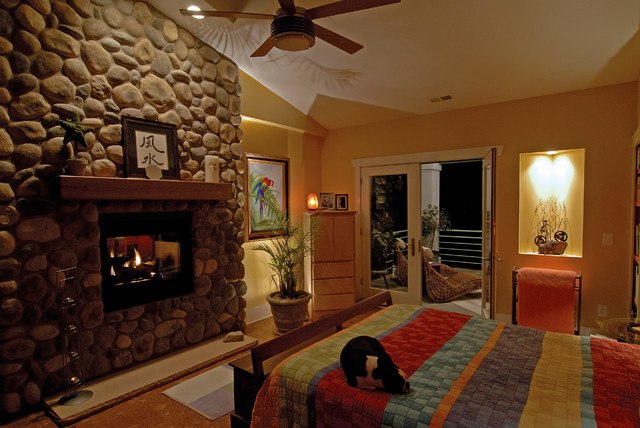 bedroom with vaulted ceilings and large fireplace