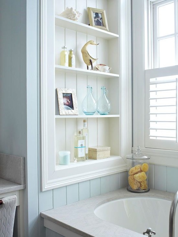 bathroom with built in shelving in shower area