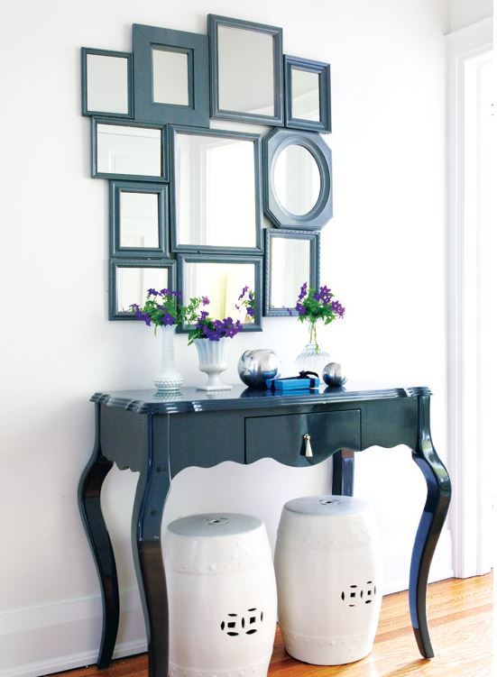 entry table with mirrors hanging above